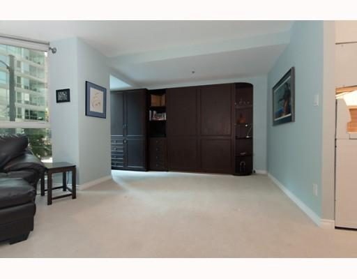 Spacious living room with dark wood cabinetry and a cozy corner sofa, perfect for downtown Vancouver living.