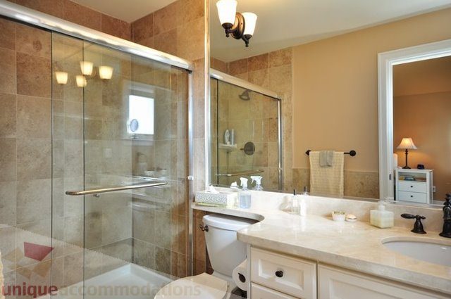 Furnished bathroom with granite countertops and a walk-in shower. - 341 East 8th Street, North Vancouver