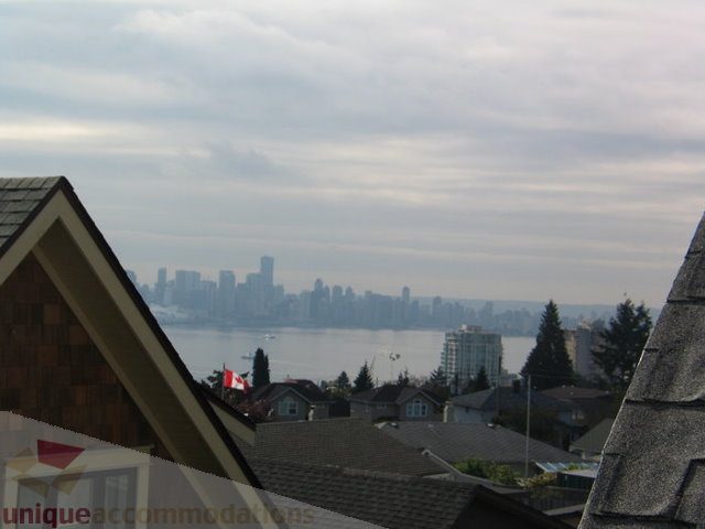 Bright living room with a stunning city view and modern furnishings. - 341 East 8th Street, North Vancouver