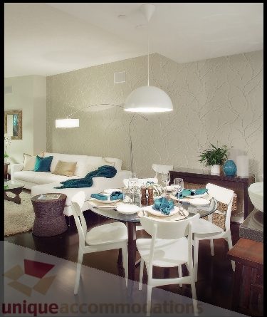 Furnished dining area with modern lighting and patterned walls. - Townhouse 117 - 118 Drake Street, Vancouver Downtown