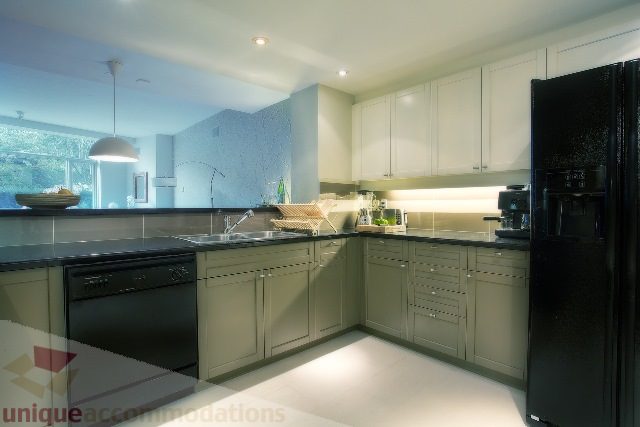 Bright kitchen with modern appliances, granite countertops, and a city view. - Townhouse 117 - 118 Drake Street, Vancouver Downtown