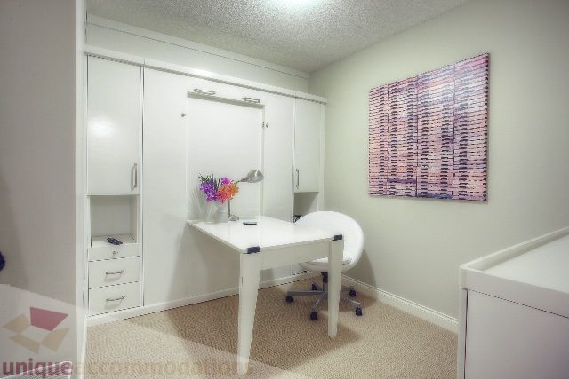 Bright bedroom with white furniture and a colorful wall art piece. - Townhouse 117 - 118 Drake Street, Vancouver Downtown