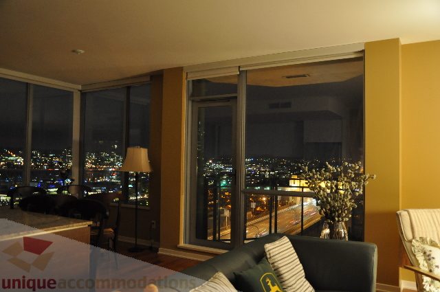 Furnished living room with city view and modern decor. - 1602 - 1005 Beach Ave., Vancouver Downtown