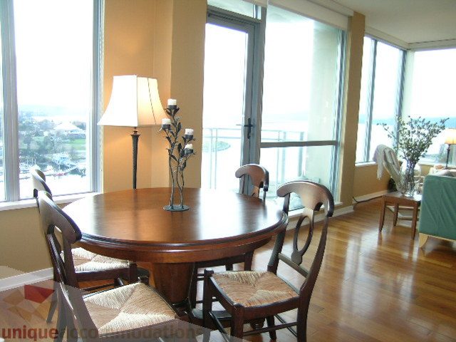 Furnished dining area with hardwood floors, city view, and modern decor. - 1602 - 1005 Beach Ave., Vancouver Downtown