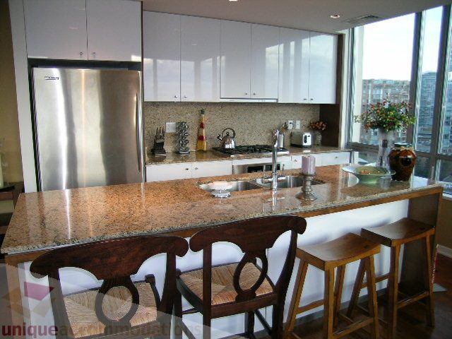 Bright kitchen with granite countertops, stainless steel appliances, and a city view. - 1602 - 1005 Beach Ave., Vancouver Downtown