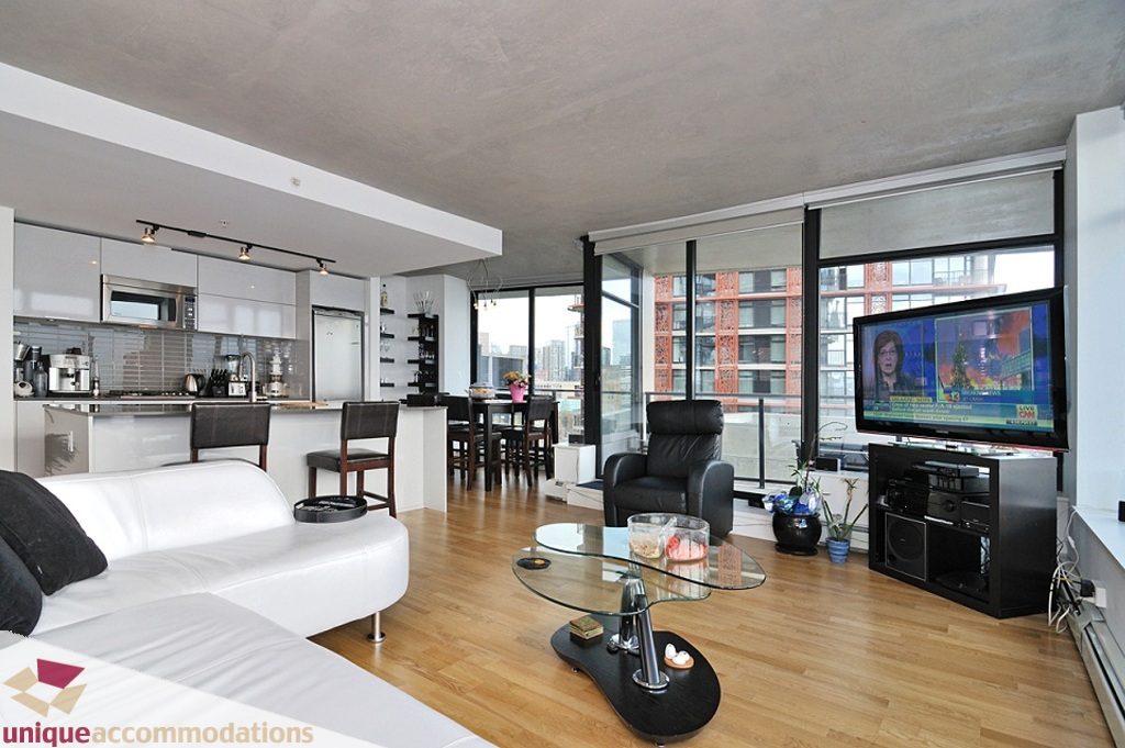Spacious living room with hardwood floors, city view, and modern furnishings. - 1409 - 108 West Cordova, Vancouver Downtown