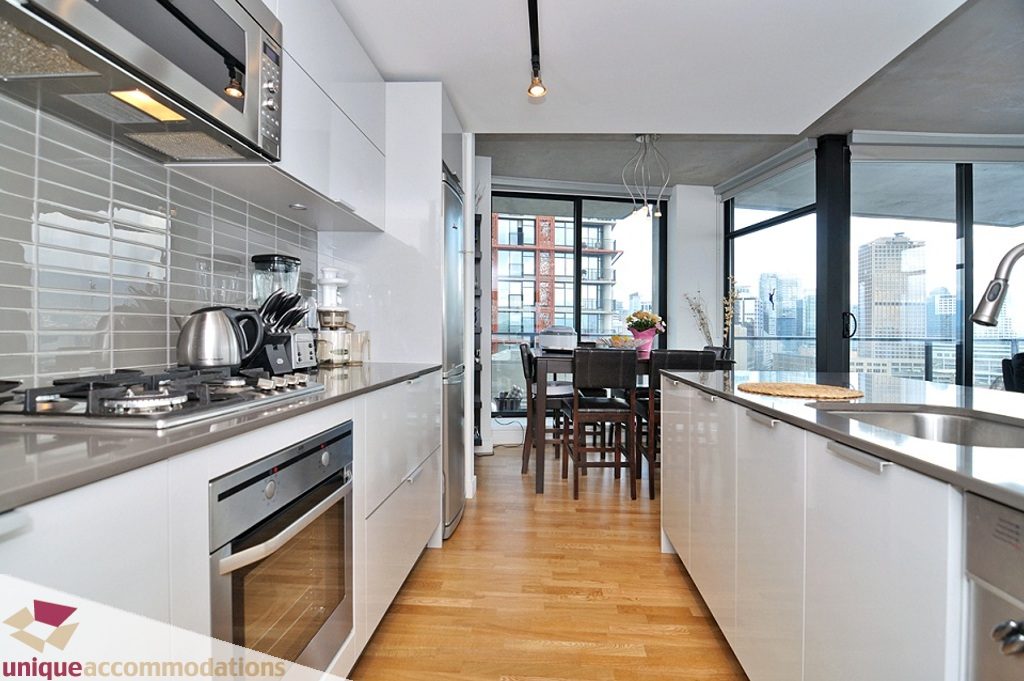 Bright kitchen with modern appliances, hardwood floors, and a stunning city view. - 1409 - 108 West Cordova, Vancouver Downtown