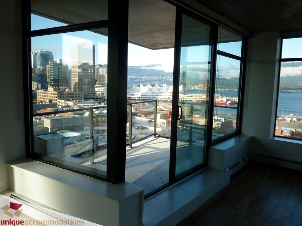 Spacious living room with large windows offering a stunning city view and waterfront panorama. - 1409 - 108 West Cordova, Vancouver Downtown