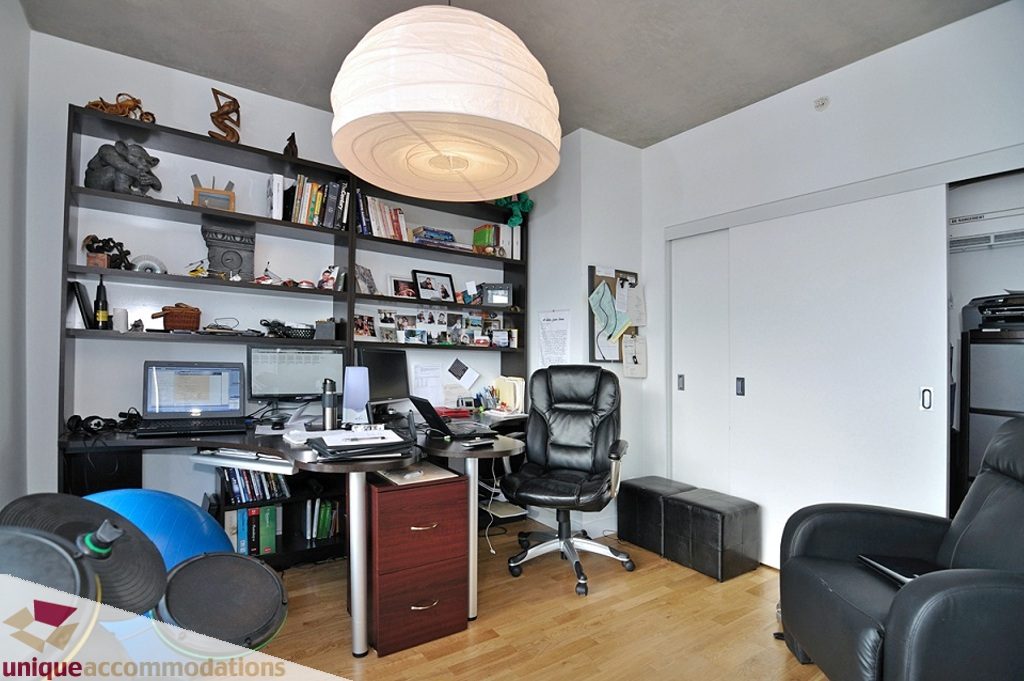 Spacious, well-lit home office with modern desk, shelving, and comfortable seating. - 1409 - 108 West Cordova, Vancouver Downtown