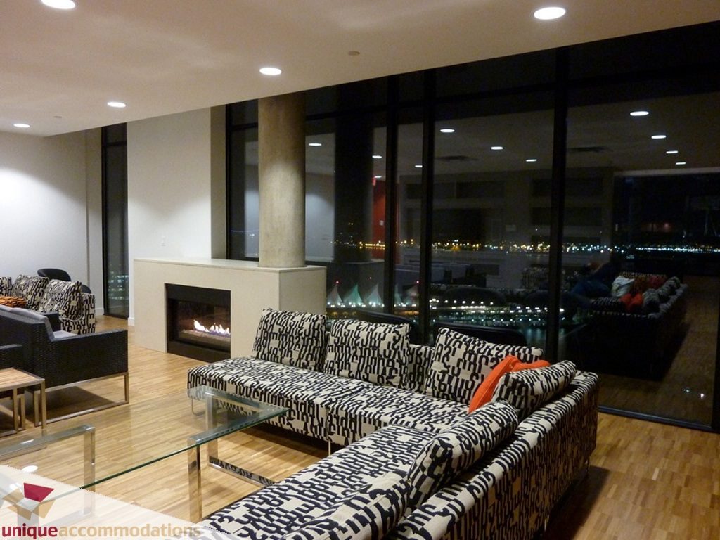 Spacious living room with patterned sofas, hardwood floors, and a city view. - 1409 - 108 West Cordova, Vancouver Downtown