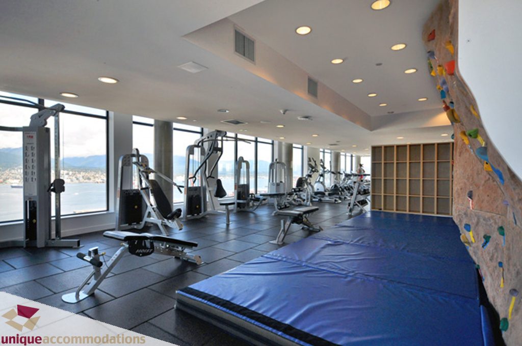 Spacious fitness room with city views, equipped with weight machines and climbing wall. - 1409 - 108 West Cordova, Vancouver Downtown