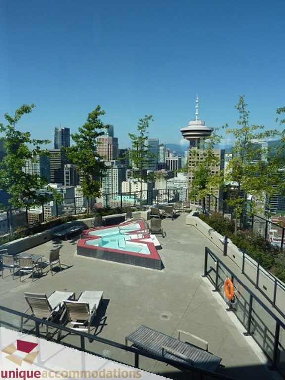 Spacious rooftop terrace with a hot tub, city skyline view, and lounge seating. - 1409 - 108 West Cordova, Vancouver Downtown