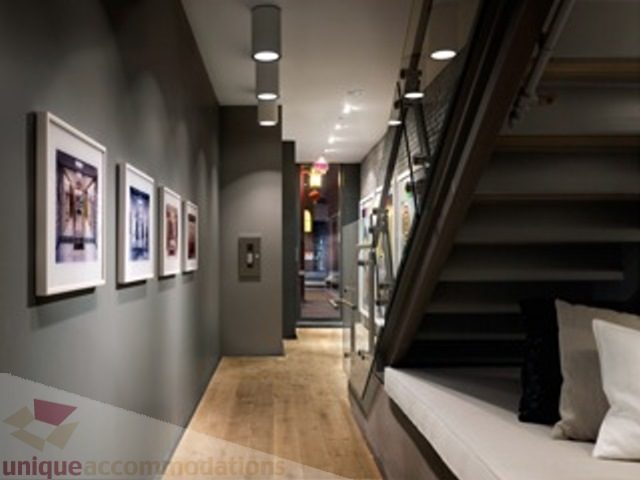 Loft bedroom with bunk beds, hardwood floors, and framed art on the wall. - 20 - 133 Keefer Street, Vancouver Downtown