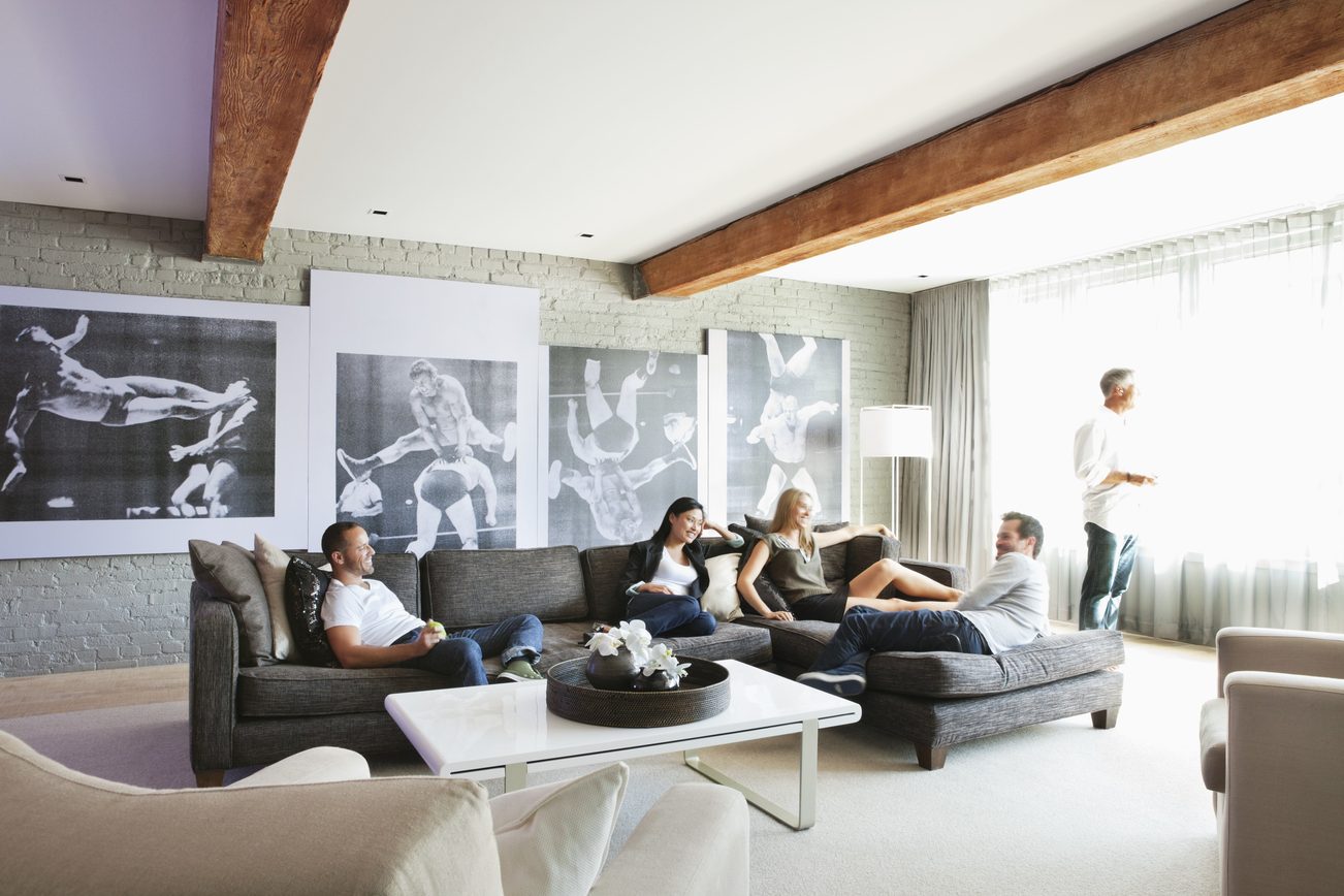 Furnished living room with modern decor, large windows, and black-and-white sports art on the walls. - 30 - 133 Keefer Street, Vancouver Downtown