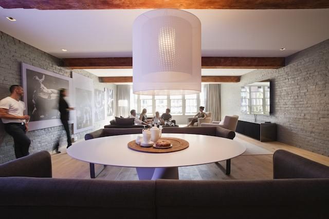 Furnished living room with exposed brick walls, large windows, and modern lighting. - 30 - 133 Keefer Street, Vancouver Downtown