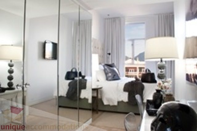 Bright and airy loft with large windows, modern decor, and a cozy bed setup. - 30 - 133 Keefer Street, Vancouver Downtown