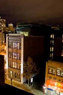 Loft with exposed brick walls and modern furnishings, city view at night. - 40 - 133 Keefer Street, Vancouver Downtown
