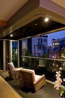 Furnished loft with cozy seating and city view at dusk. - 40 - 133 Keefer Street, Vancouver Downtown