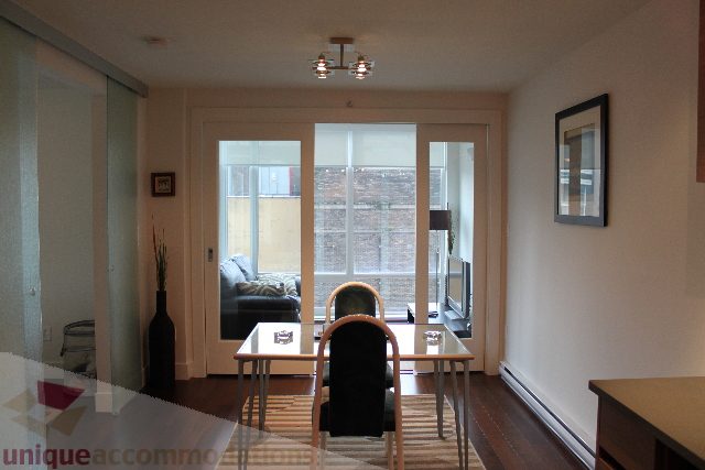 Bright living room with large windows and city view. - 705 - 565 Smithe Street, Vancouver Downtown