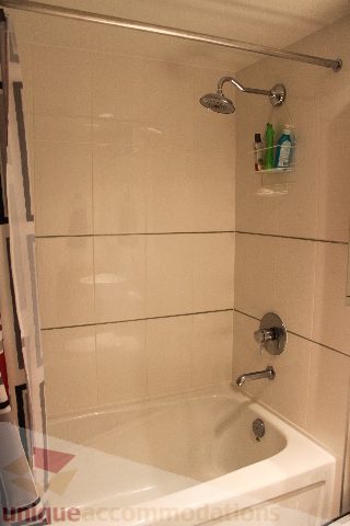 Bathroom with shower and bathtub, neatly organized. - 705 - 565 Smithe Street, Vancouver Downtown
