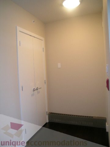 Spacious bathroom with white door and black countertop. - 1309 Civic Place Mews, North Vancouver