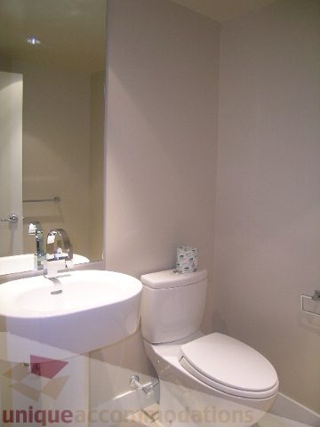 Modern bathroom with sleek white sink and toilet, clean and minimalistic design. - 1309 Civic Place Mews, North Vancouver