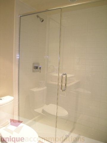 Modern bathroom with glass shower and sleek fixtures. - 1309 Civic Place Mews, North Vancouver