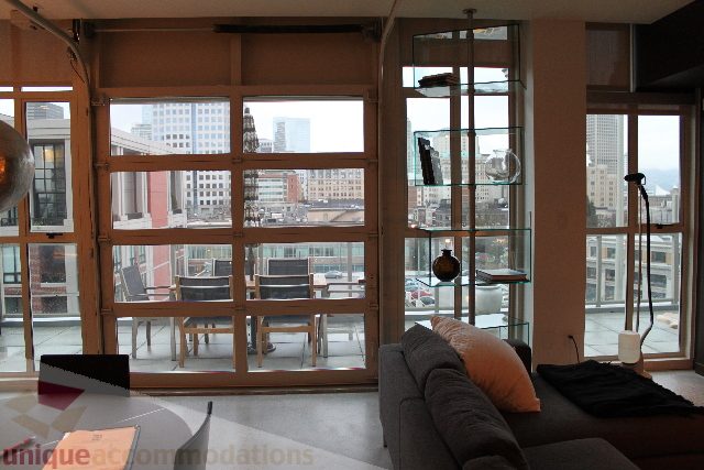 Furnished living room with city view and modern decor. - 701 - 546 Beatty Street, Vancouver Downtown
