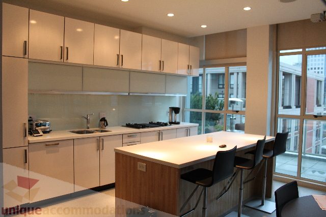 Bright kitchen with white countertops and city view, modern design. - 701 - 546 Beatty Street, Vancouver Downtown