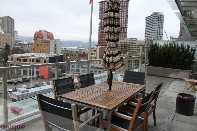 Furnished rooftop patio with city views and outdoor seating. - 701 - 546 Beatty Street, Vancouver Downtown