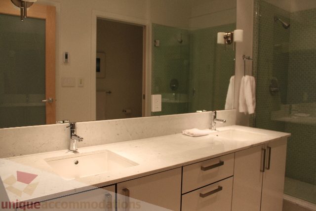 Modern bathroom with white countertop and green mosaic tiles. - 701 - 546 Beatty Street, Vancouver Downtown