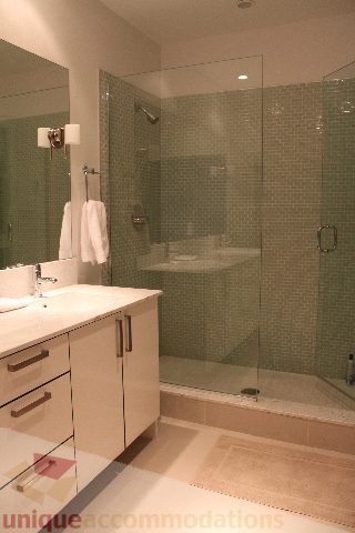 Bright bathroom with white countertop and glass shower enclosure. - 701 - 546 Beatty Street, Vancouver Downtown