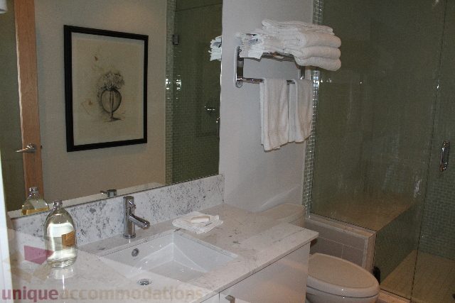 Bathroom with marble countertop and framed artwork. - 701 - 546 Beatty Street, Vancouver Downtown
