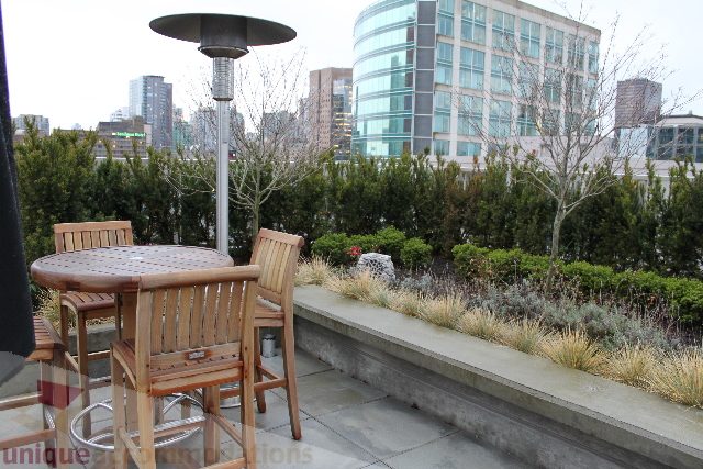 Furnished patio with city view, outdoor furniture, and greenery. - 701 - 546 Beatty Street, Vancouver Downtown