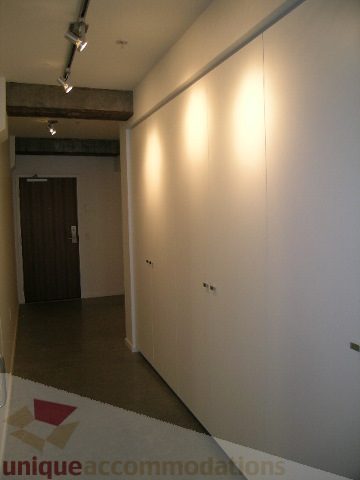 Furnished hallway with white walls and recessed lighting. - 216 - 388 West 1st Avenue, Vancouver West Side