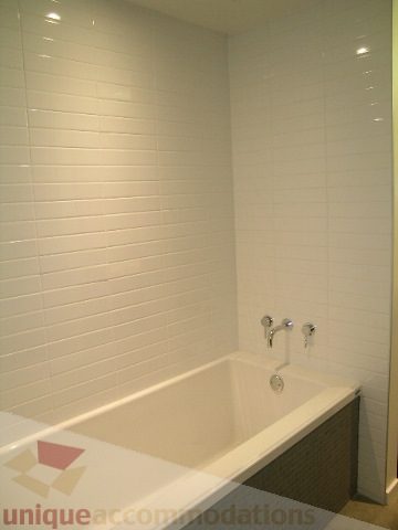 Bright bathroom with white subway tiles and modern faucet. - 216 - 388 West 1st Avenue, Vancouver West Side