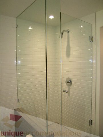 Bright bathroom with glass shower and white subway tile. - 216 - 388 West 1st Avenue, Vancouver West Side