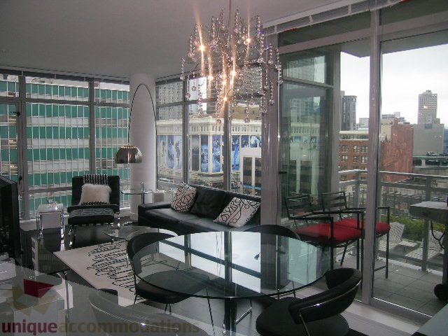 Furnished dining area with glass table, black chairs, and city view. - 1106 - 788 Richards Street, Vancouver Downtown