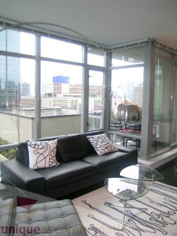Furnished living room with city view and modern decor. - 1106 - 788 Richards Street, Vancouver Downtown