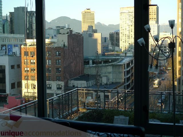 Furnished living room with city view and modern decor. - 1106 - 788 Richards Street, Vancouver Downtown