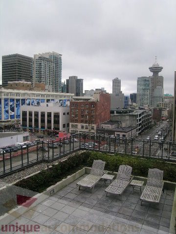 Furnished rooftop lounge with city view and lounge chairs. - 1106 - 788 Richards Street, Vancouver Downtown