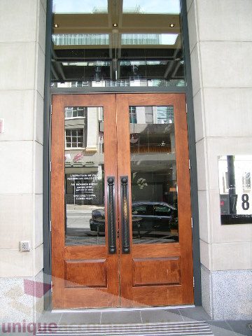 Furnished living room with wooden doors and glass panels, showcasing city views. - 1106 - 788 Richards Street, Vancouver Downtown