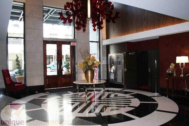 Furnished living room with modern decor, large windows, and a stylish chandelier. - 1106 - 788 Richards Street, Vancouver Downtown