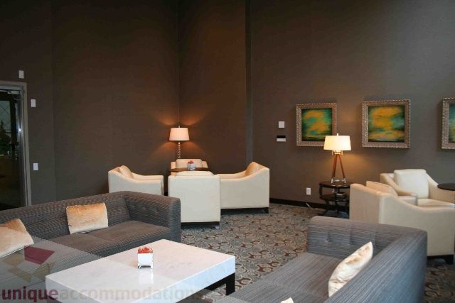 Furnished living room with modern furniture, wall art, and ambient lighting. - 1106 - 788 Richards Street, Vancouver Downtown