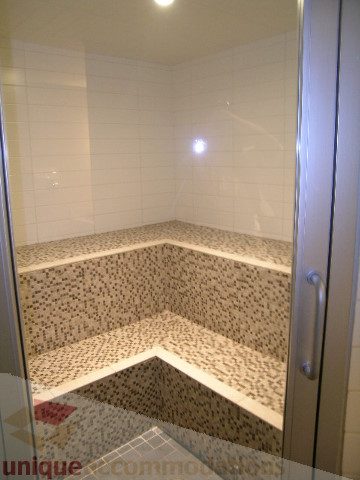 Furnished shower with mosaic tile bench seating and glass doors. - 1106 - 788 Richards Street, Vancouver Downtown