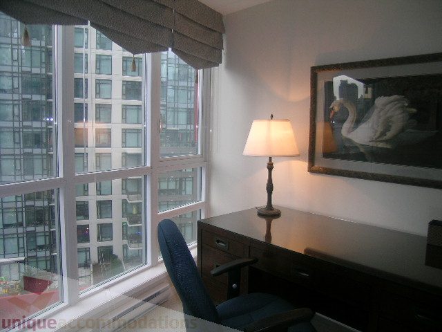 Bright and airy office with city view, desk, lamp, and framed swan artwork. - 907 - 1189 Melville Street, Vancouver Downtown