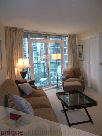 Furnished living room with city view and modern decor. - 907 - 1189 Melville Street, Vancouver Downtown