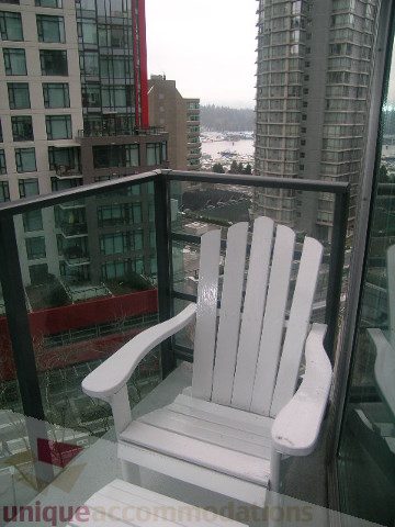 Bright balcony with white Adirondack chairs, city view, modern furnishings. - 907 - 1189 Melville Street, Vancouver Downtown