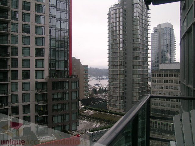 Furnished 1-bedroom + den with city view and modern glass facade. - 907 - 1189 Melville Street, Vancouver Downtown
