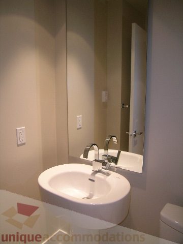 Modern bathroom with sleek sink and large mirror, offering a clean and contemporary feel. - 1903 - 1320 Chesterfield Street, North Vancouver